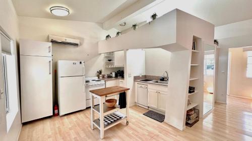 a kitchen with a white refrigerator and a wooden floor at Echo Park Hills in Los Angeles