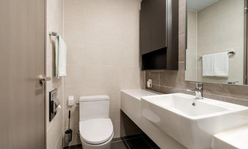 a bathroom with a white toilet and a sink at Radiant Nampo Hotel in Busan