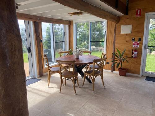 a dining room with a wooden table and chairs at The Lookout Chalet luxury getaway retreat in Farnborough