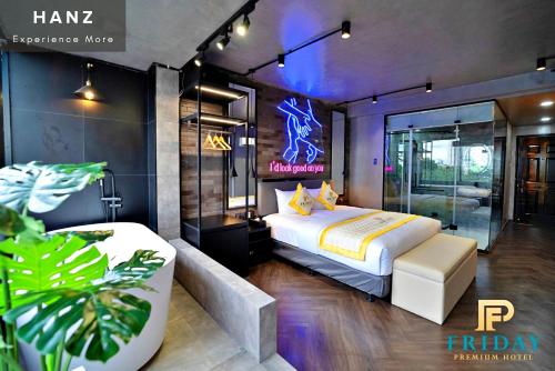 a hotel room with a bed and a couch at HANZ Premium Friday Hotel in Ho Chi Minh City