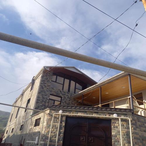 a building with a pole in front of it at Lahij Rashad Ismayilov Hotel in Lahıc