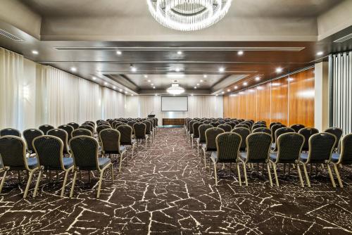 a conference room with chairs and a podium at Quality Hotel Parklake Shepparton in Shepparton