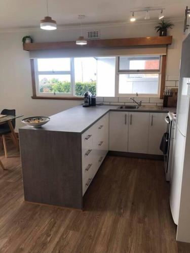 a kitchen with a island in the middle of a room at Devonport's Relax at Manning in Devonport