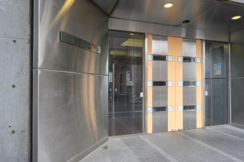 an entrance to a building with two glass doors at Nakajima Park stay AMS tower Nakajima 16F in Sapporo