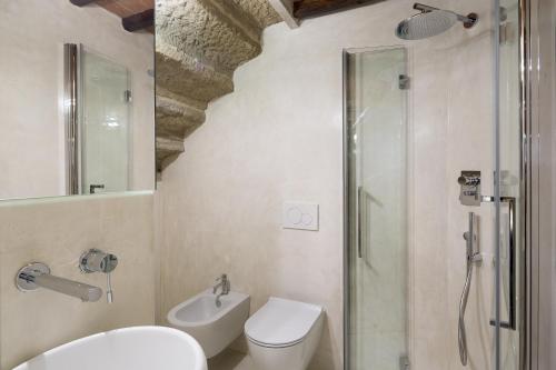 a bathroom with a shower and a toilet and a sink at Loft n°18 in Arezzo
