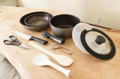 a table with a bunch of kitchen utensils on it at Saku House Jujo in Tokyo