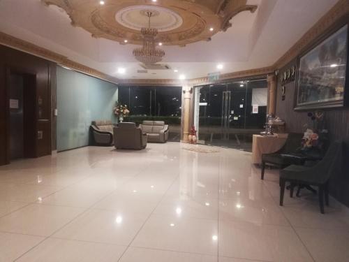 a large room with a lobby with couches and chairs at The Ardens Hotel - Nong Chik, Kolam Air, Johor Bahru in Johor Bahru