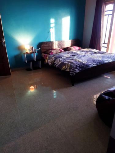 a bedroom with a bed and a window at Kumaon Lake's Home stay in Nainital