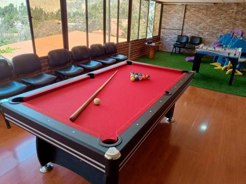 a red pool table in a room with chairs at Oasis del Placer MOYDA in La Paz