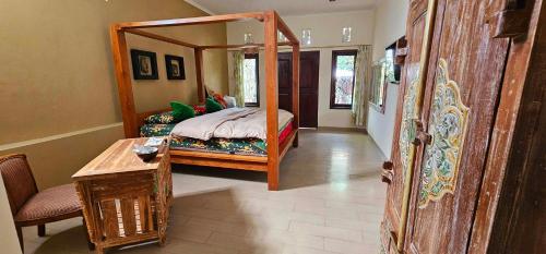 a bedroom with a bed with a large mirror at The GWK View in Jimbaran