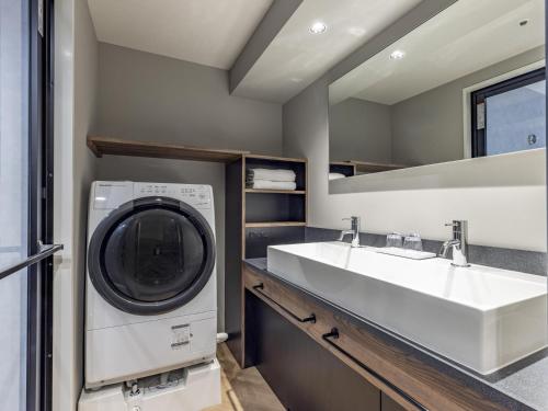 a laundry room with a washing machine and a sink at Tokyu Stay Nishi Shinjuku in Tokyo