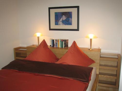 a bedroom with a bed with red pillows at Senda 517 C in Scuol