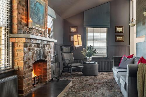 a living room with a brick fireplace and a couch at Sovereign Hill Hotel in Ballarat