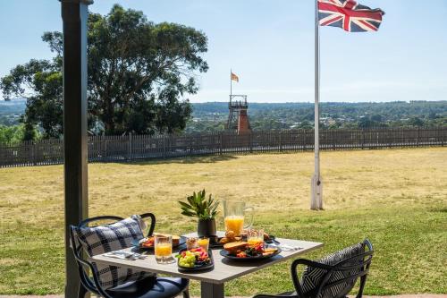 a table with food and a flag on a field at Sovereign Hill Hotel in Ballarat