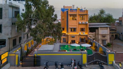 a group of people riding bikes in front of a building at The Hosteller Jodhpur in Jodhpur