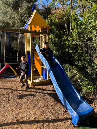 two boys playing on a slide at a playground at Villa del Mar in Mali Lošinj