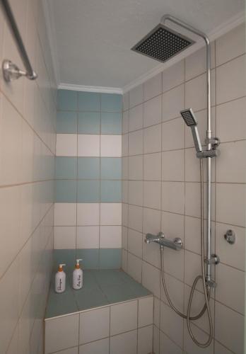 a bathroom with a shower with two bottles in it at Achilleas guest house in Litochoro