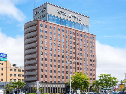 a building with a sign on the top of it at Route Inn Grantia Hakodate Ekimae in Hakodate