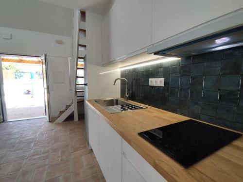 a kitchen with a sink and a counter top at 28 Casa do Avô - 2Km from the beach in Sesimbra