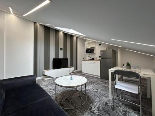 a living room with a couch and a table at Sara Boutique Villa in Constanţa