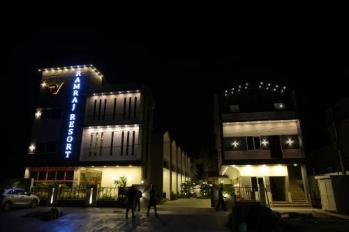 a building with a blue sign on it at night at Ramraj Resort in Kanyakumari