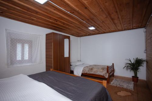 a bedroom with two beds and a window at Kulla Pracja Theth in Theth