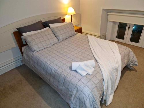a bedroom with a bed with two towels on it at McMahon Suite - Central CBD in Christchurch