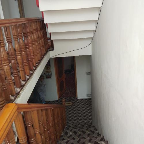 a hallway with a staircase and a stair case at Elizabeth paying guest house Tangmarg gulmarg in Gulmarg