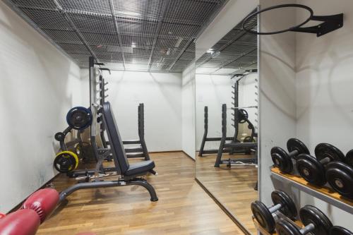 a gym with treadmills and exercise equipment in a room at Hotel Klaus K in Helsinki