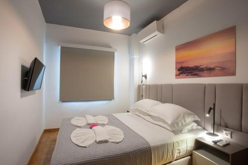 a bedroom with a bed with towels on it at Aonia Luxurious Modern Boutique Apartments in Chalkida