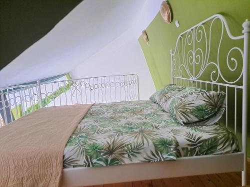 a bedroom with a bed with a white bed frame at Gallery apartment in Podgorica