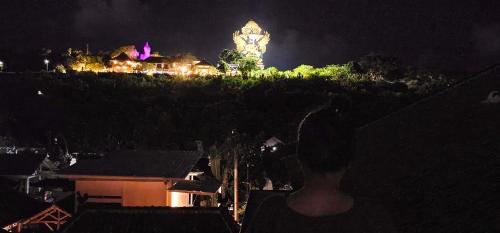 a clock tower on top of a hill at night at The GWK View in Jimbaran