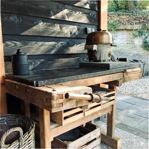 a wooden stove with a pot on top of it at Veluwe vakantiehuis - Bosuil Lodge in Lunteren