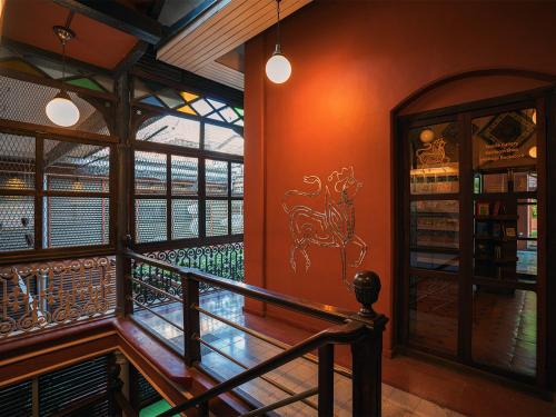 a room with a staircase and a stained glass window at The House of MG-A Heritage Hotel, Ahmedabad in Ahmedabad