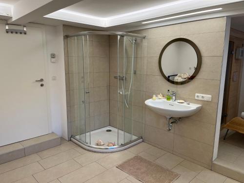 a bathroom with a shower and a sink and a mirror at Haus Erzbergblick in Eisenerz