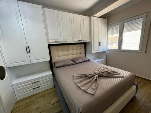 a bedroom with a bed with a bow on it at GOLEM Best Apartment in Golem