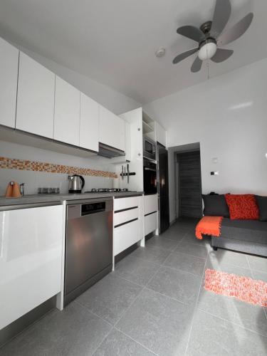 een keuken met witte kasten en een plafondventilator bij Self-catering apartment in a stunning location with poll & hot tub in Oria