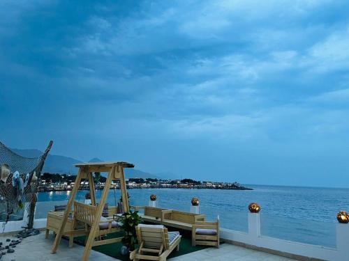 a patio with chairs and a view of the water at Club Red Dahab Motel in Dahab