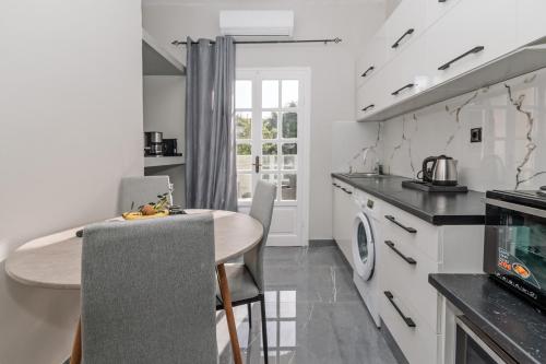 a kitchen with a table and chairs in a room at Pelithea Family Resort in Corfu