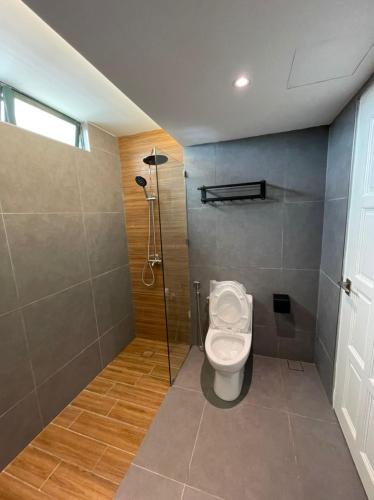 a bathroom with a toilet and a shower at Condo Istana Penthouse in langkawi in Kuah
