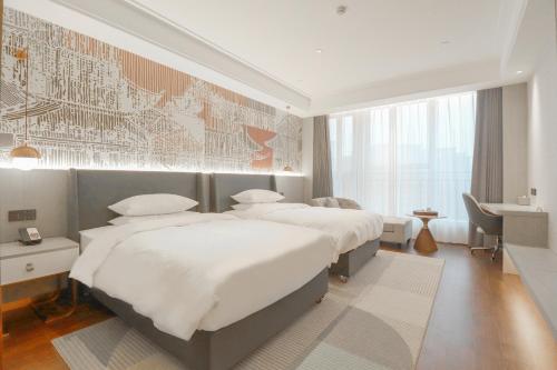 Postelja oz. postelje v sobi nastanitve Anxi Huiting Hotel
