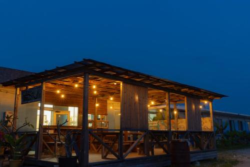a wooden building with a deck at night at the Sanctuary Kohama Retreat in Kohama