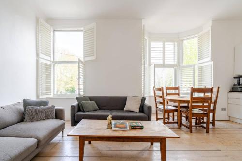 a living room with a couch and a table at Blue Valley House in London