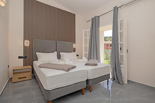Postel nebo postele na pokoji v ubytování Pelithea Family Aparthotel