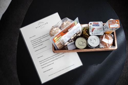 a tray filled with food and a piece of paper at Dunetton - self check-in hotel in Klaipėda