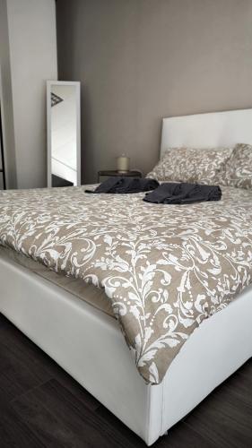 a bedroom with a bed with a white comforter and a mirror at Eveve's House in Parma