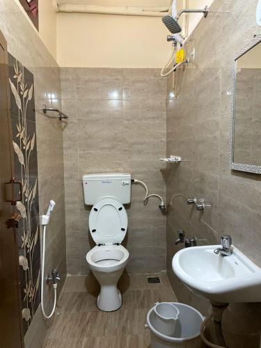 a bathroom with a toilet and a sink at Paradise Sunrise Beach Villa in Kottakupam