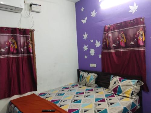 a bedroom with a bed and two red curtains at Paradise Sunrise Beach Villa in Kottakupam