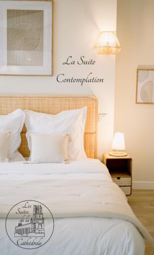 - une chambre avec un lit blanc et un panneau mural dans l'établissement Les Suites de la Cathédrale, à Albi