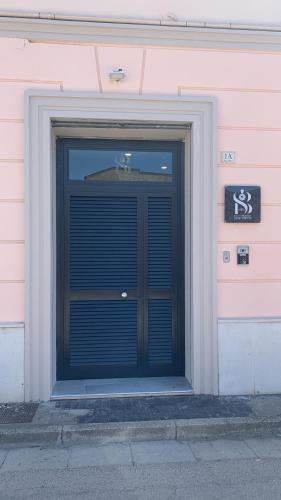 a building with a black door with a sign on it at B&B Smart Station Caserta in Caserta